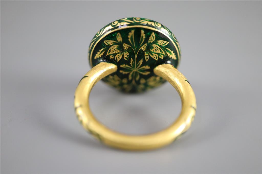 An antique Mogul gold, green enamel and cabochon natural red spinel set ring, size K.